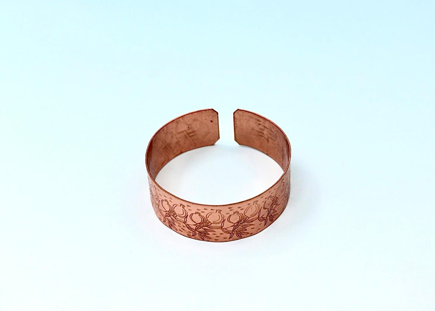 copper bracelet engraved with pomegranates