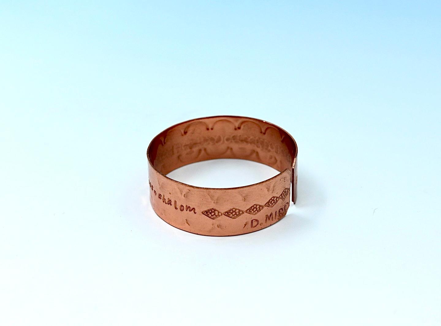 copper bracelet engraved with  seven blessings.