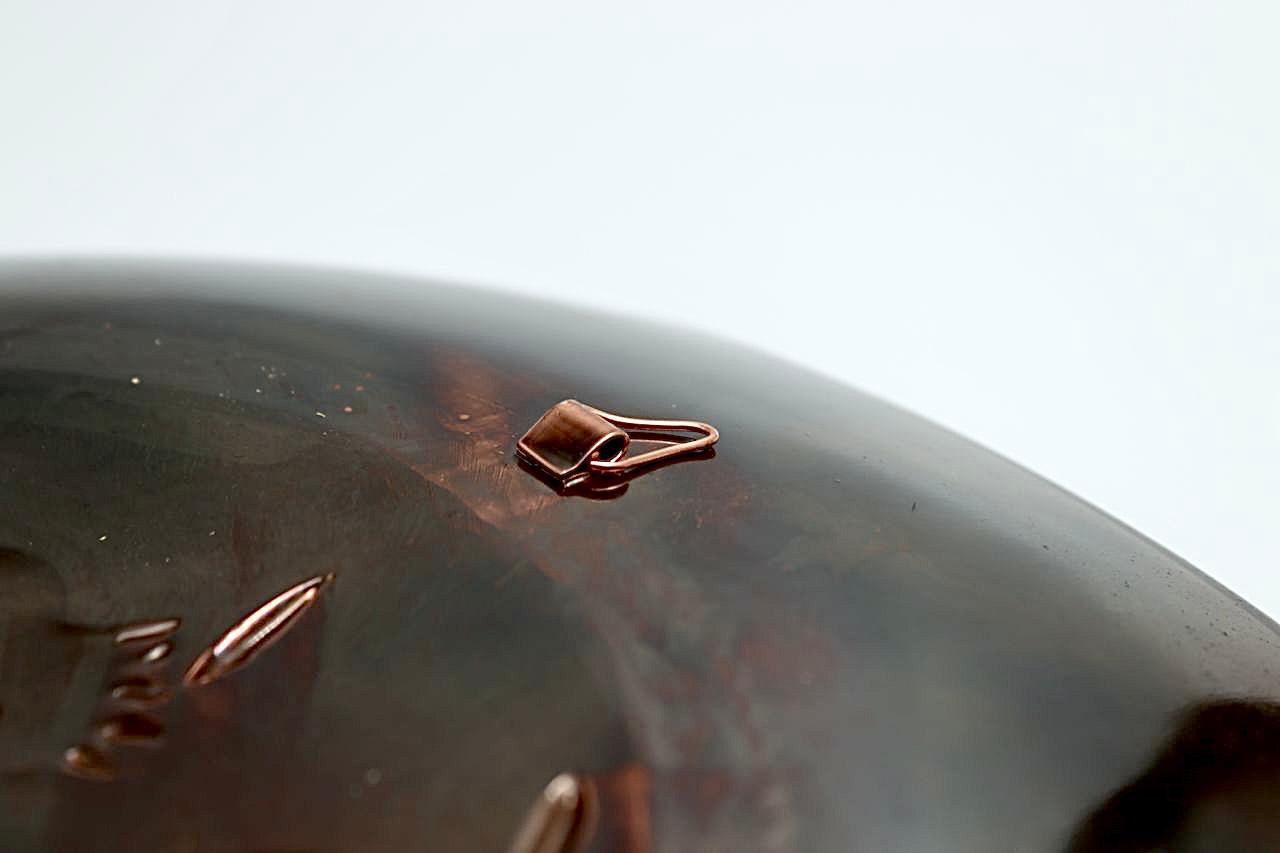 Copper hammering of pomegranates, partially blackened