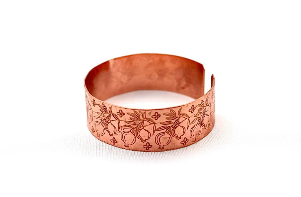 Handmade copper bracelet engraved with pomegranates