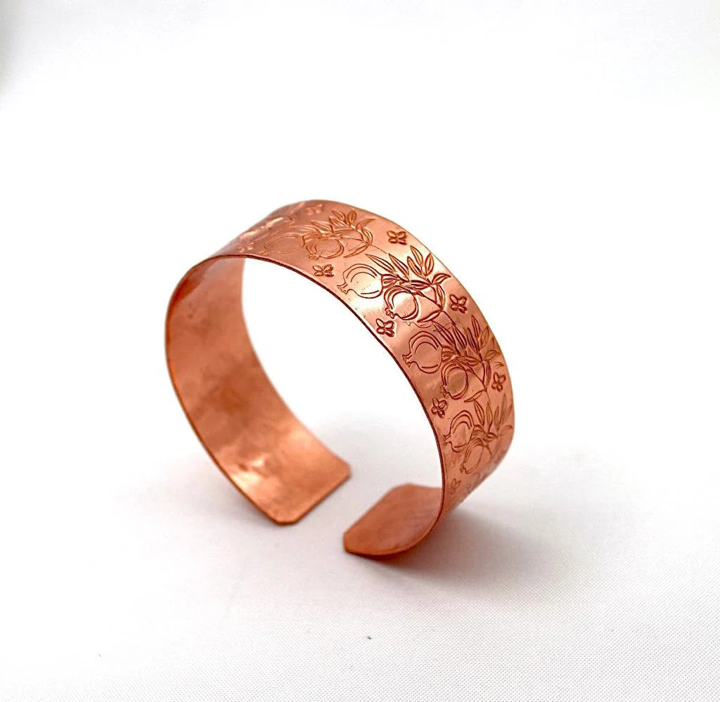 Handmade copper bracelet engraved with pomegranates