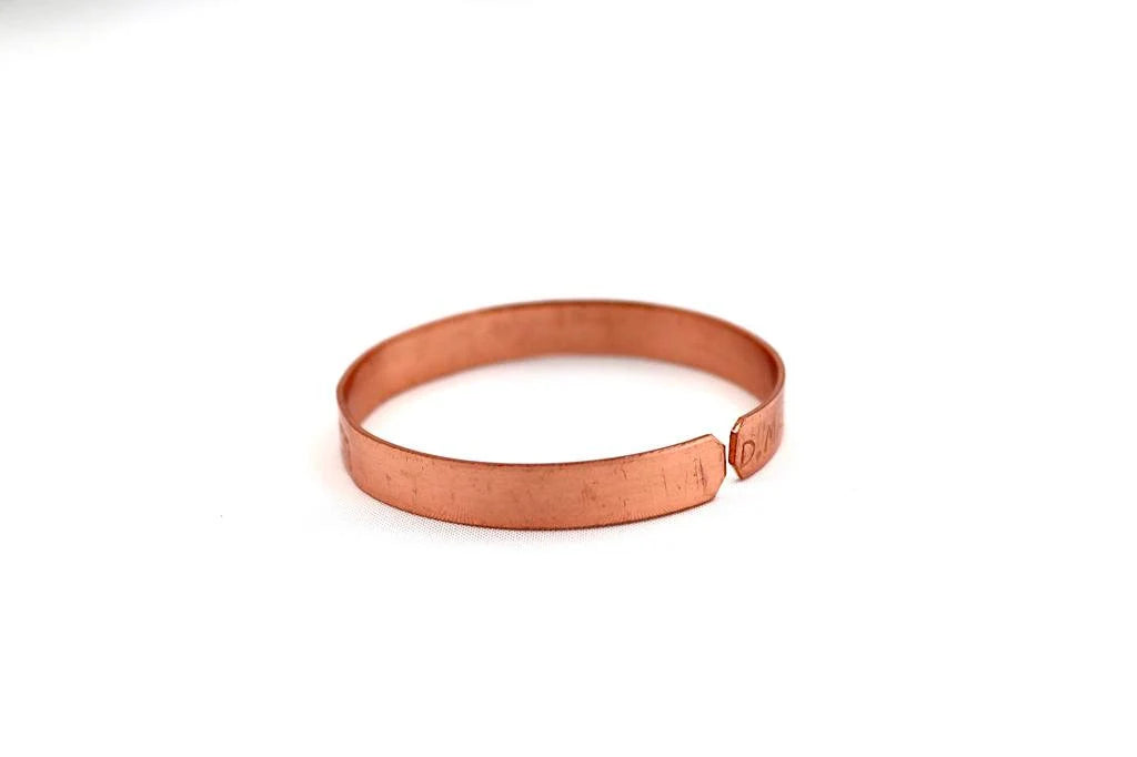 copper bracelet engraved "and in whatsoever he doeth he shall prosper" in Hebrew.