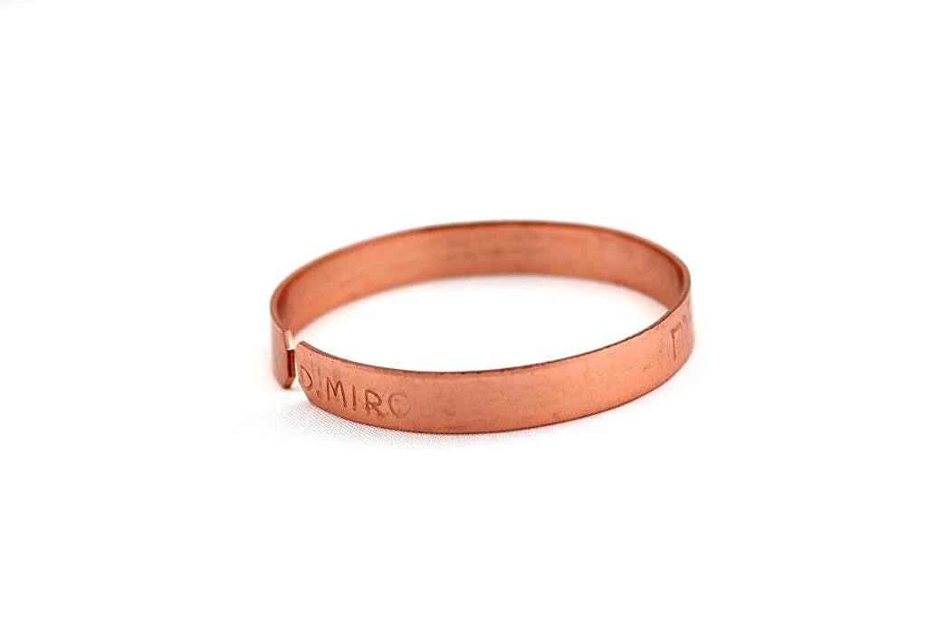 copper bracelet engraved "and in whatsoever he doeth he shall prosper" in Hebrew.