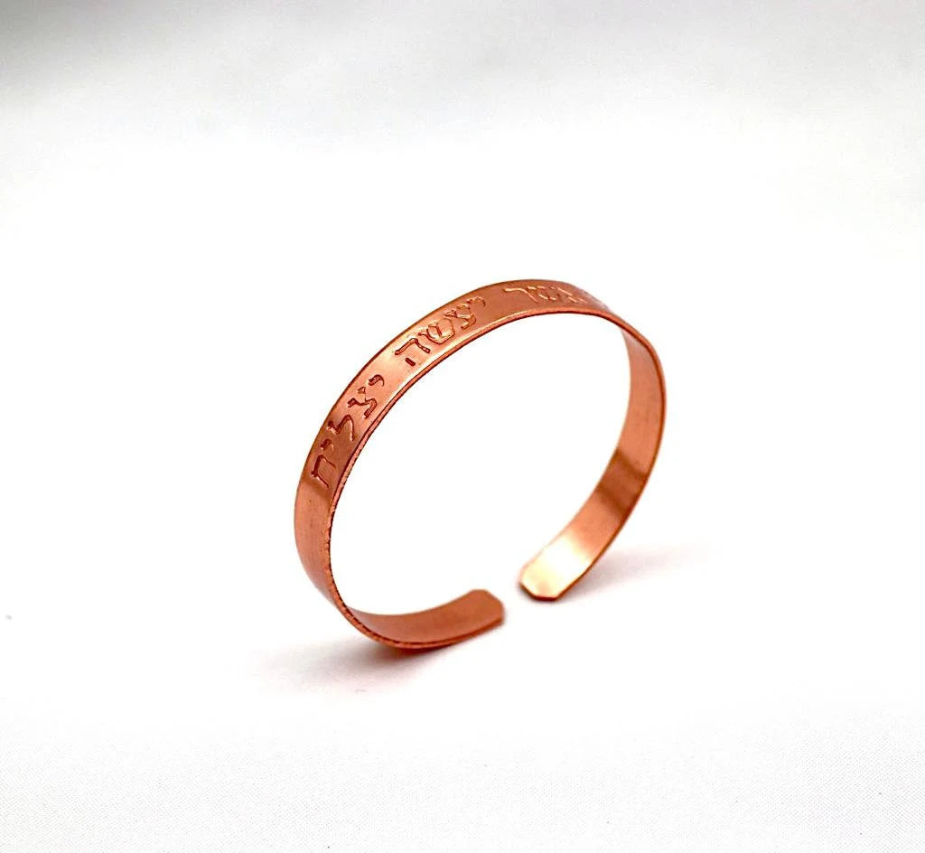 copper bracelet engraved "and in whatsoever he doeth he shall prosper" in Hebrew.